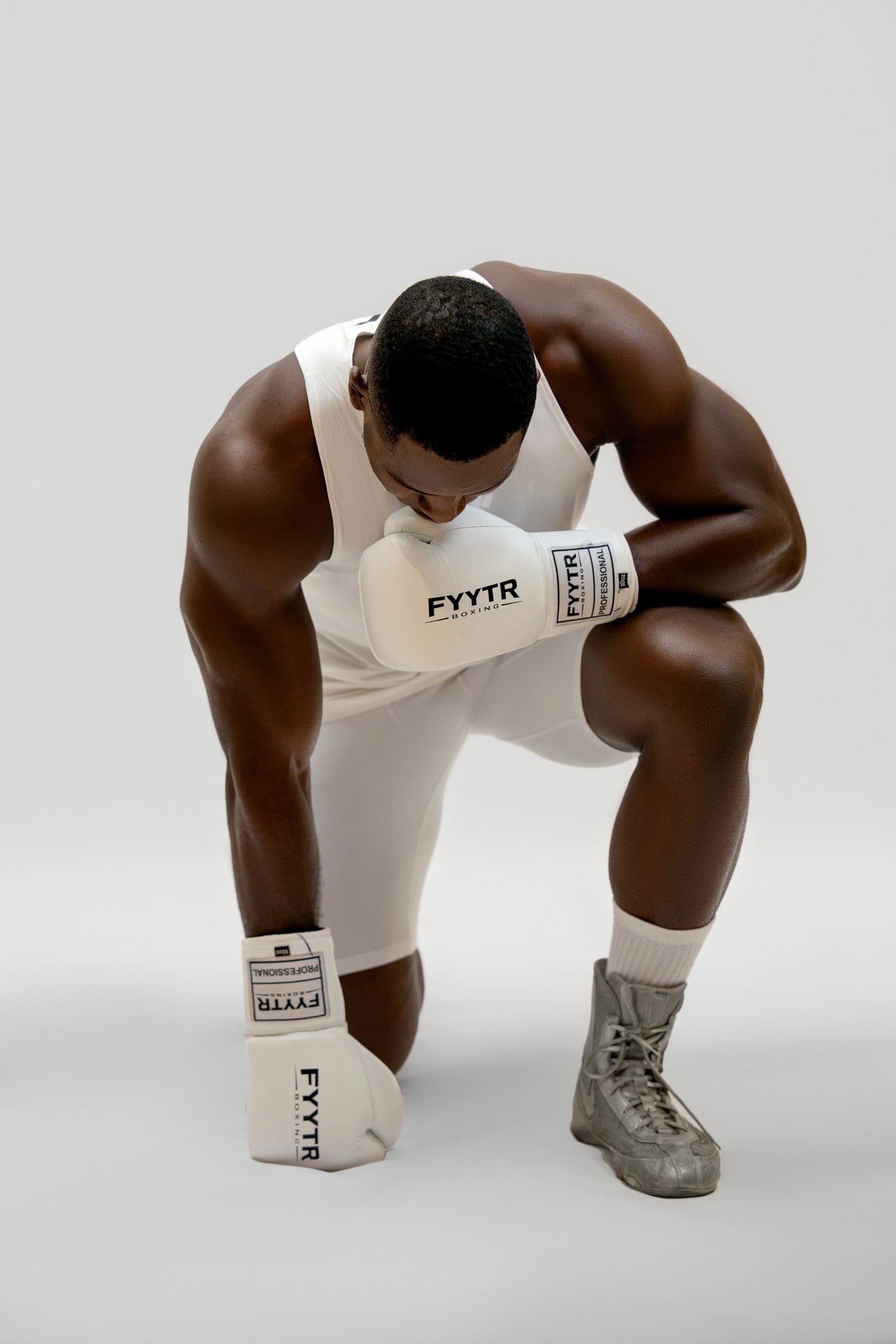 A pair of white FYYTR boxing gloves