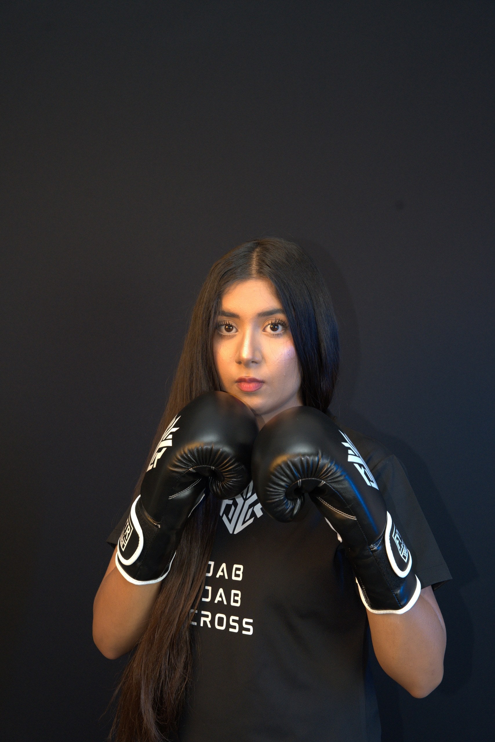 Boxer in guard stance wearing black FYYTR training gloves