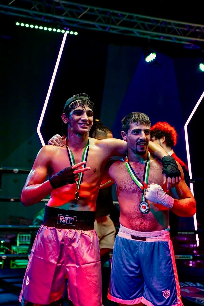 Two amateur boxers with medals around their necks after their bouts