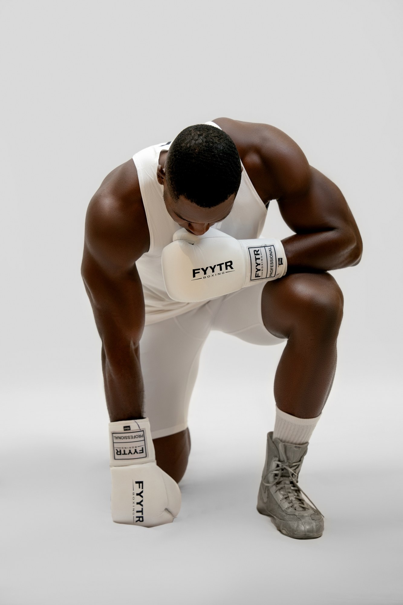 A pair of white FYYTR boxing gloves