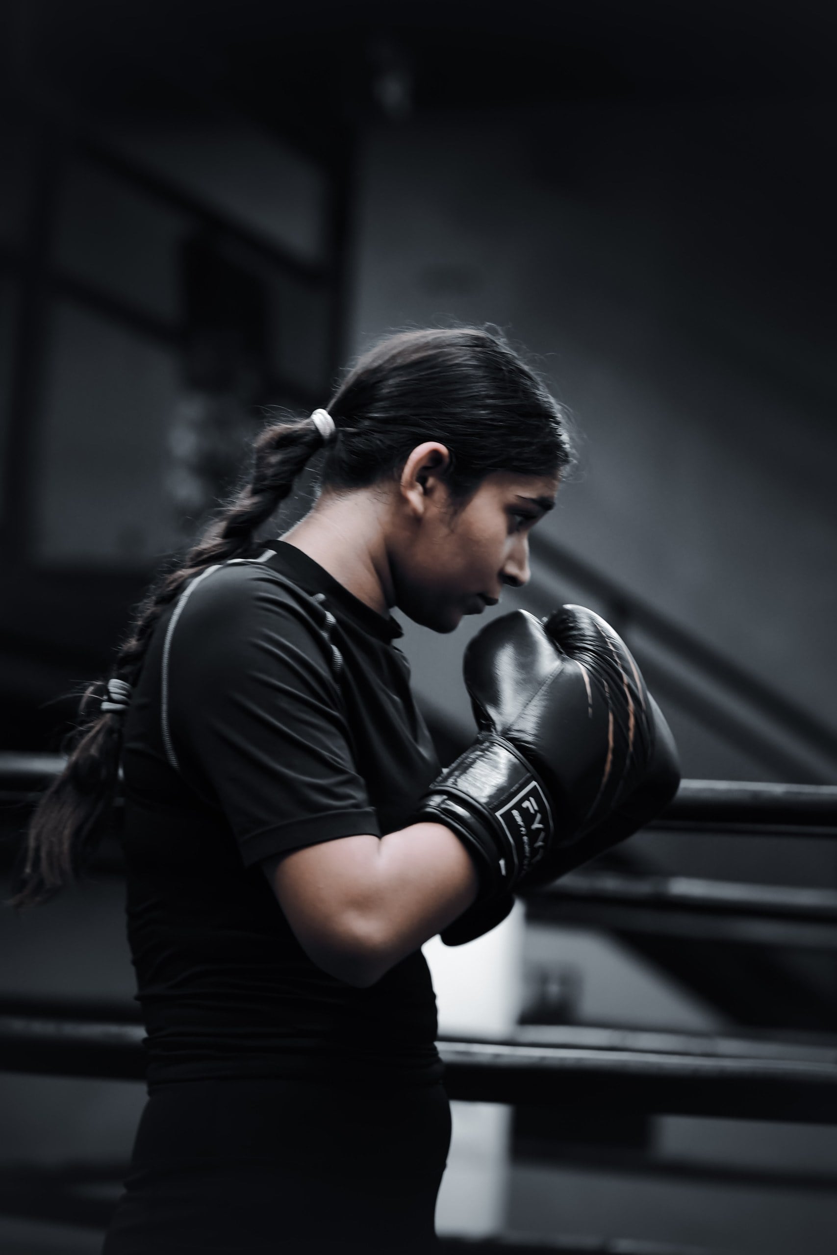 Boxer in guard stance wearing black FYYTR training gloves