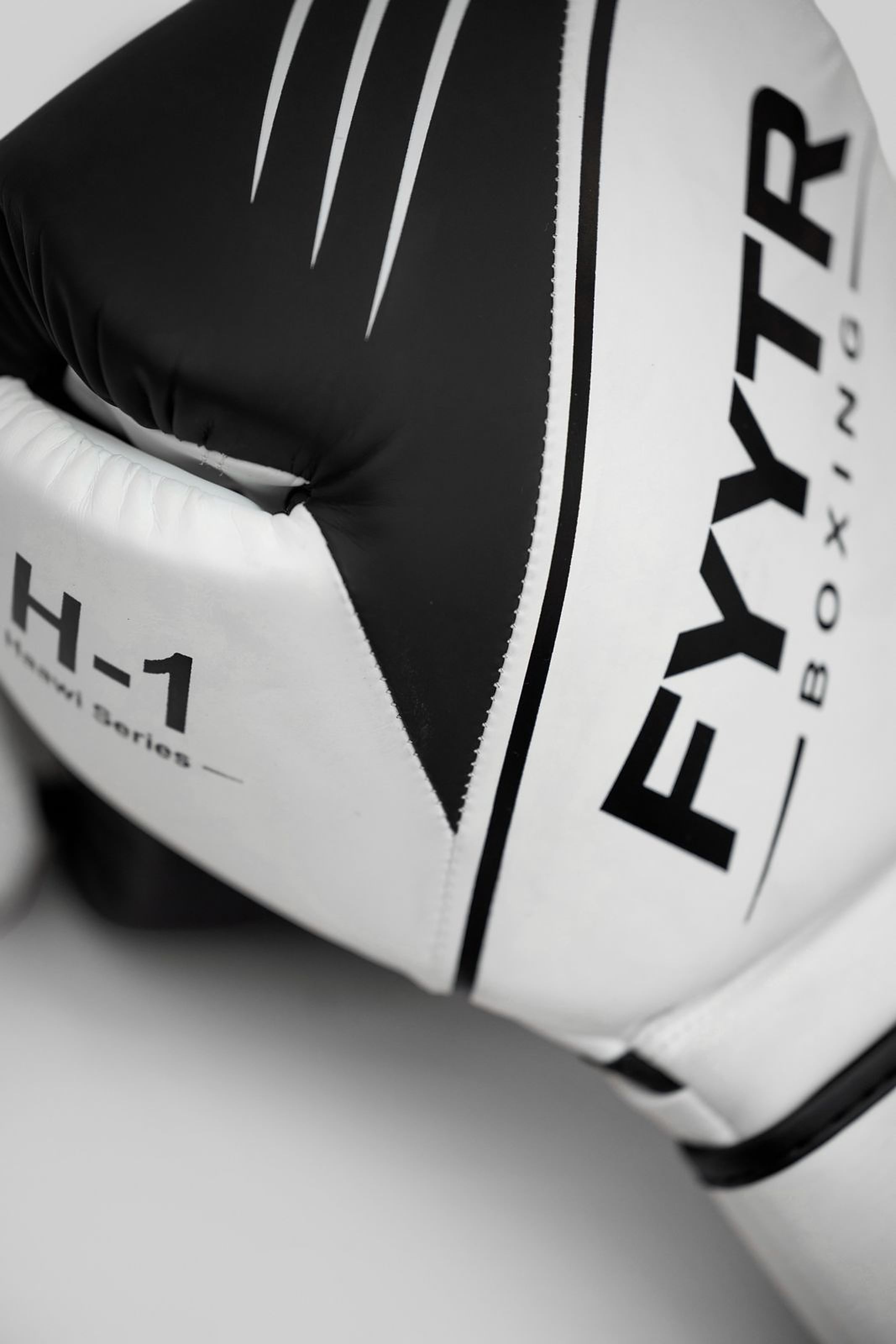 Close-up of a black and white FYYTR Haawi H-1 boxing glove
