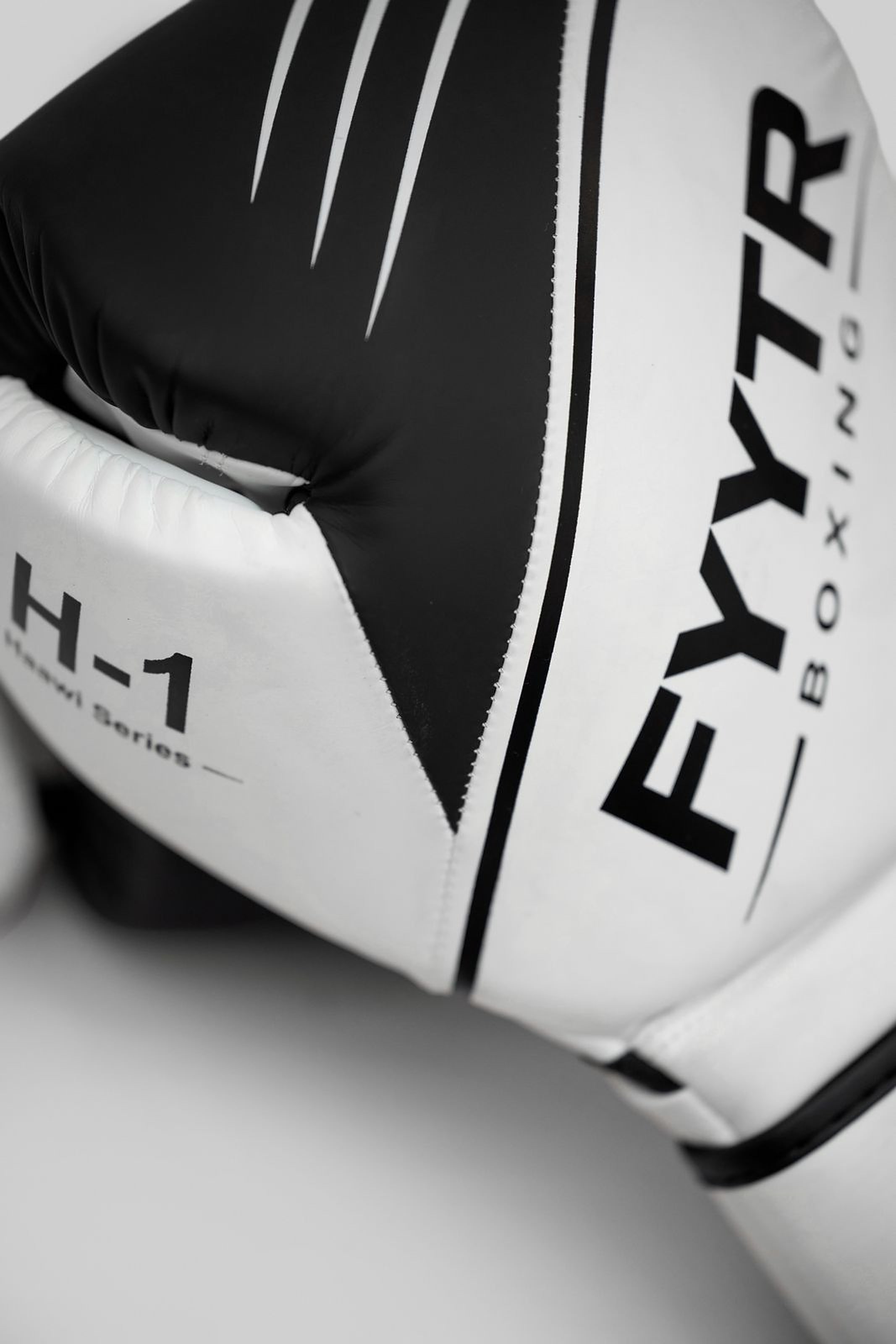 Close-up of a black and white FYYTR Haawi H-1 boxing glove